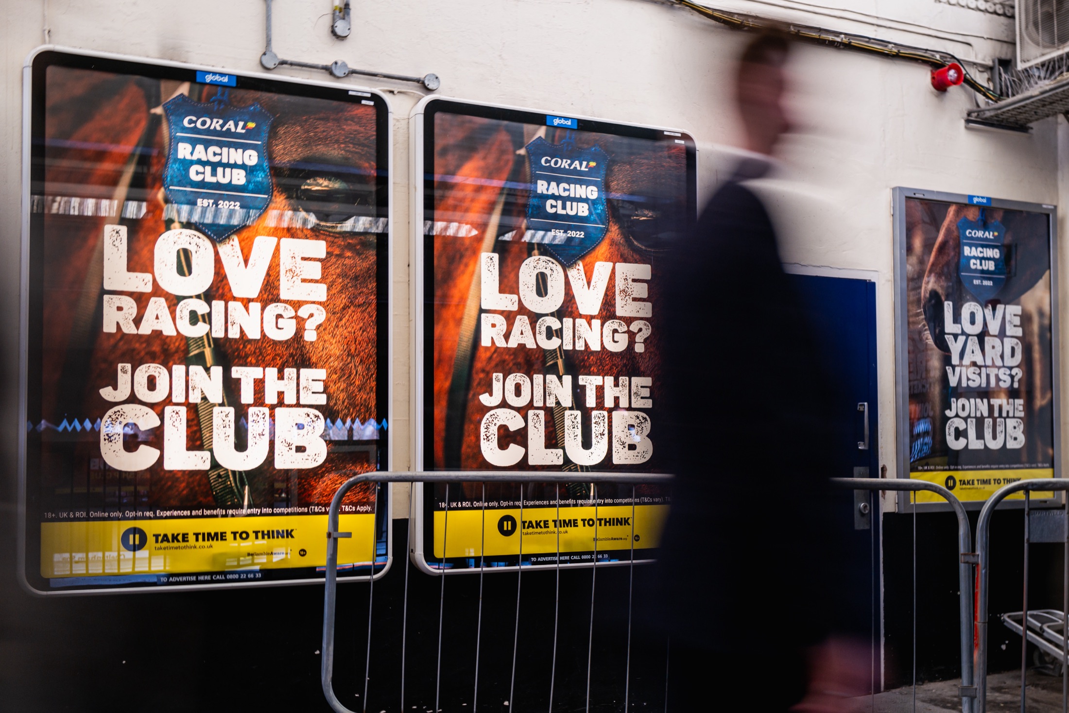 “Love racing? Join the club” posters on the platform